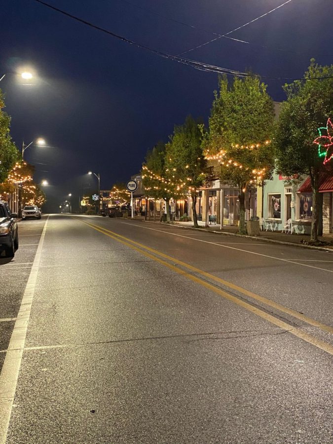 Main Street of Lucedale illuminating at night.