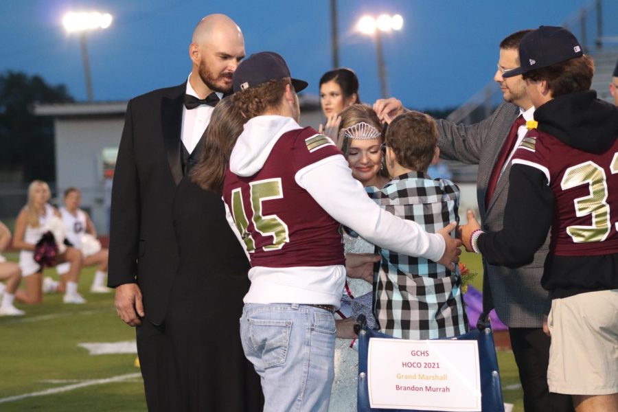 Grand Marshall Brandon Murrah crowns 2021 homecoming queen Carlie Herrington. 