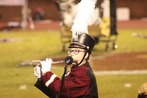  Junior Emma Croon preforms her solo part during the half-time show at the GCHS Rebels Football game.