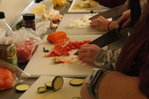 Culinary students prepare vegetables.