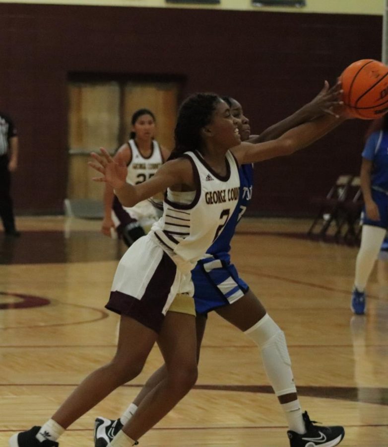 Lady Rebel Basketball player holds onto the ball.