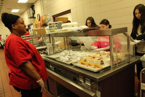 Cafeteria staff Jessie Bolton observes students as they come through the lunch line. 