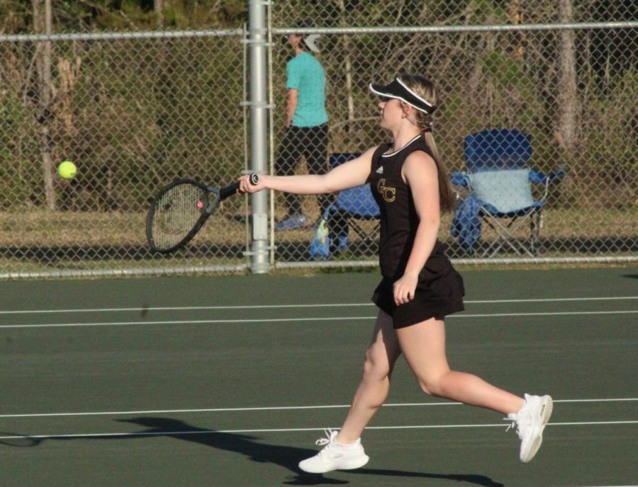 Gracie Smith runs to hit the ball back to opponent. 