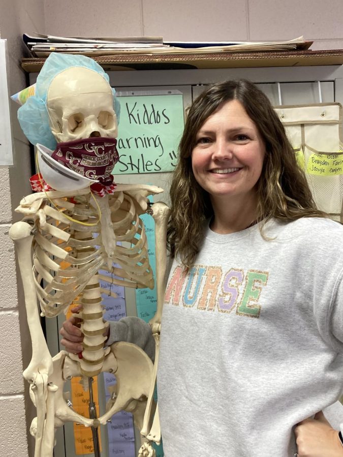 Havard poses with skeleton.