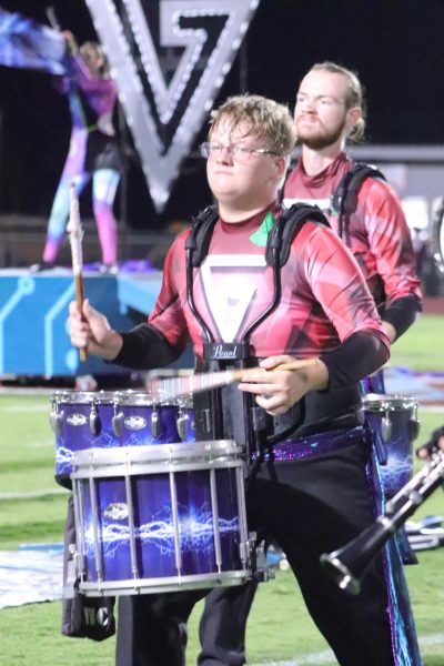 Senior Colby Grimes plays his snare drum during a halftime performance.