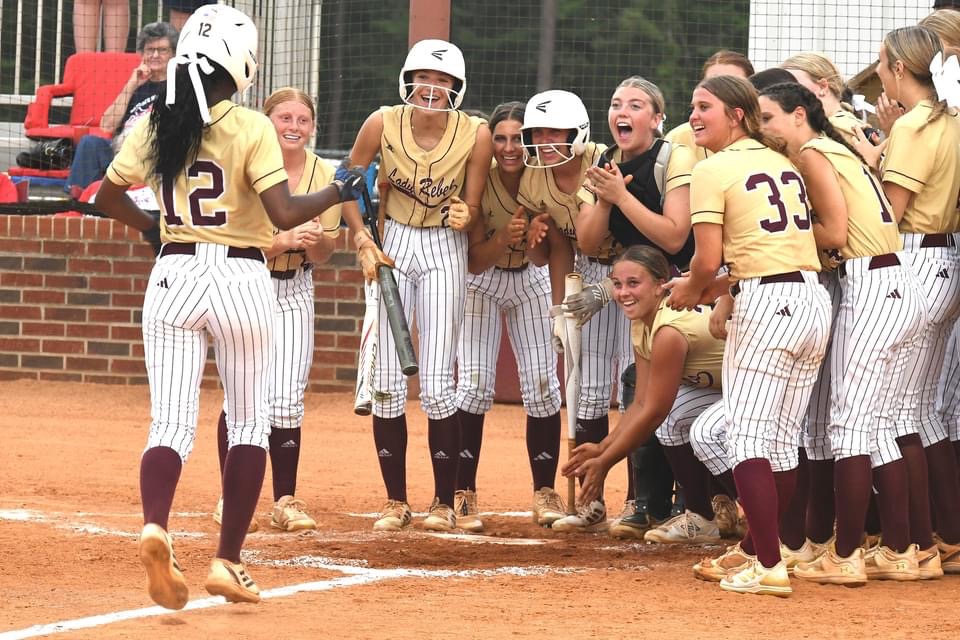 Members of the 2024 Lady Rebels softball team cheer on Jordyn Bradley after hitting a home run.