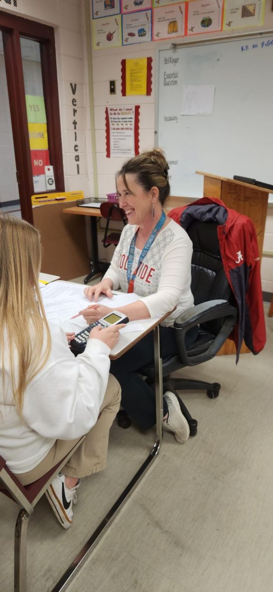 Math teacher Tracey Fryfogle assists students in her Honors Algebra I class.